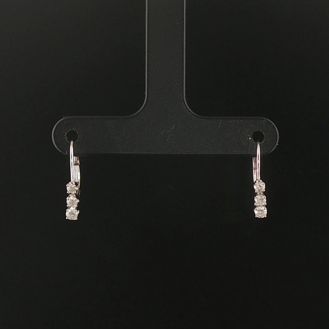 14k White Gold and 0.12cttw Graduated Diamond Small Hoop Huggie Earrings