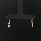 14k White Gold and 0.12cttw Graduated Diamond Small Hoop Huggie Earrings