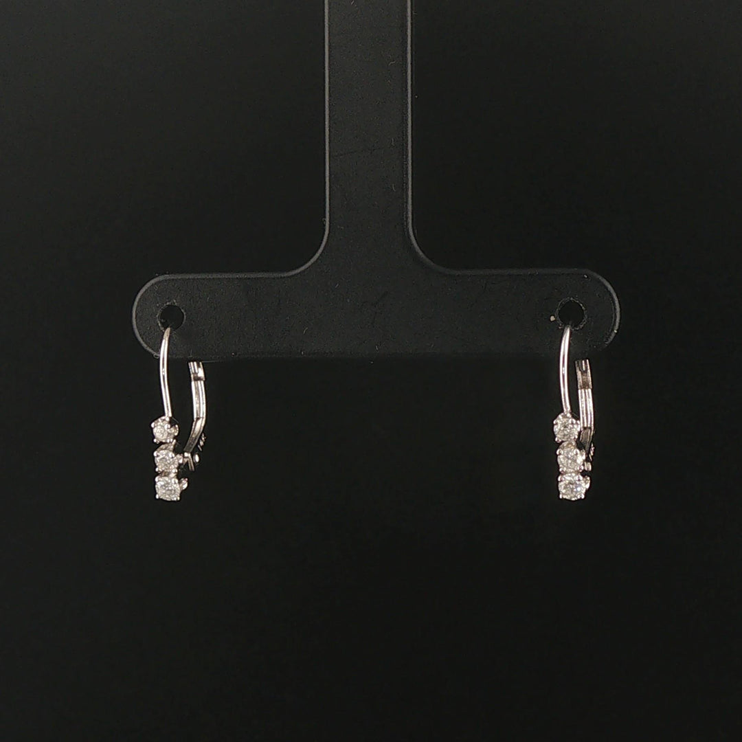 14k White Gold and 0.12cttw Graduated Diamond Small Hoop Huggie Earrings