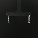 14k White Gold and 0.12cttw Graduated Diamond Small Hoop Huggie Earrings