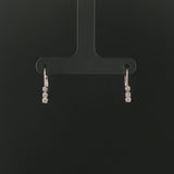14k White Gold and 0.12cttw Graduated Diamond Small Hoop Huggie Earrings